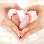baby feet in mother hands - hearth shape