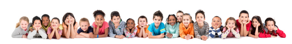 Large group of children posing isolated in white